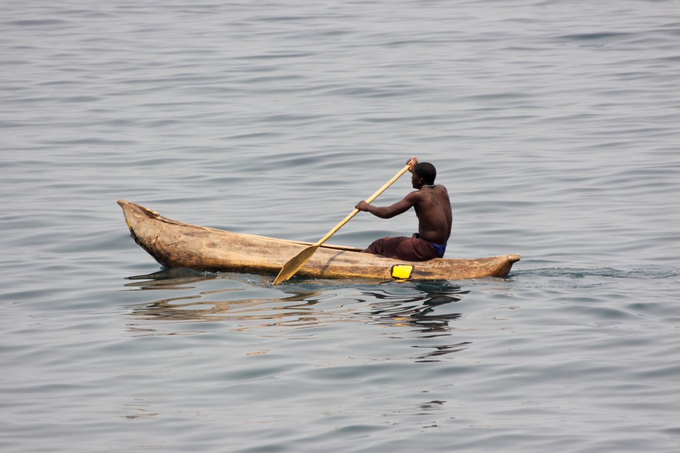 Man on a classic wooden boat